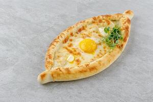 khachapuri in Adjarian style on a stone background studio food photo 2