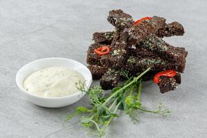 fried slices of black bread on a stone background studio food photo 2