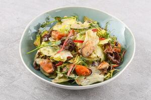 salad with mussels, sweet peppers and cucumbers on a stone background, studio food photo 2