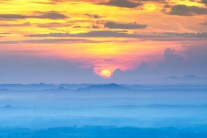 Sunrise with the fog is spreading to the horizon. photo