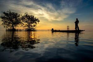 fisherman on the fishing boat photo