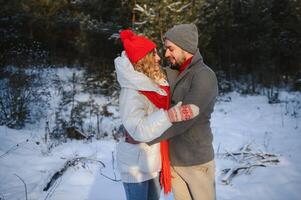 Photo of young attractive couple happy positive smile look each other enjoy time together forest winter love story