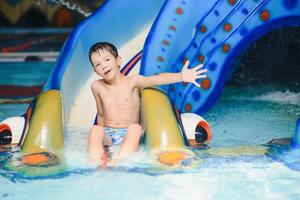 The boy is rolling with a water slide at a water park in Little Rock photo