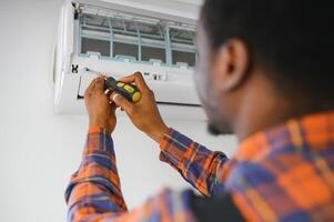 AC Electrician Technician Repairing Air Conditioner Appliance photo