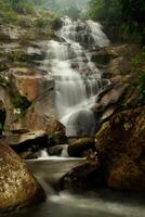 Waterfall in tropical forest photo