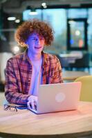 Cheerful male freelancer browsing funny video content while networking in social media using netbook technology in street cafe, happy hipster guy enjoying free time for online blogging via laptop photo
