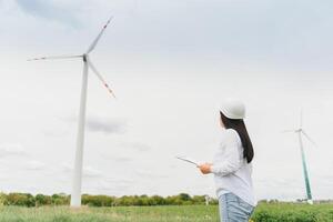 Female Engineer in a Wind Turbines Farm photo