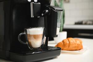 Home professional coffee machine with cappuccino cup. coffee machine latte macchiato cappuccino milk foam prepare concept photo