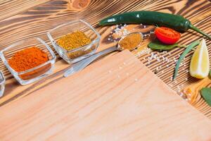 Cooking table. Background with spices and vegetables. Top view. Free space for your text. photo