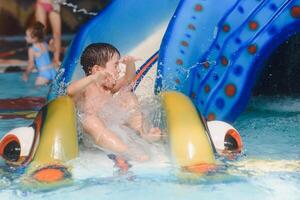 The boy is rolling with a water slide at a water park in Little Rock photo