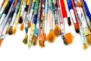 Many colorful paintbrush of artist be stained water or acrylic color isolated on white background and selective focus. Object, Tool and Art concept photo