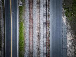an aerial view of a road with railroad tracks photo