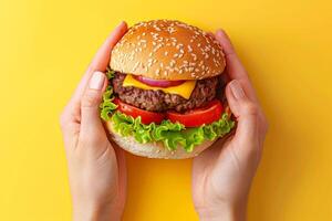 ai generado manos sostener un hamburguesa en amarillo antecedentes. generativo ai foto