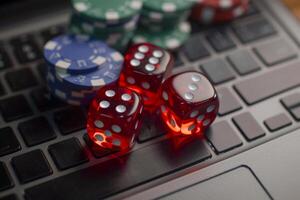 AI generated Stack of casino chips and dice lie on a laptop keyboard. Generative AI photo