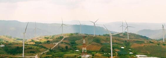 Eco energy energy concept Windmill on the hill with sunset photo