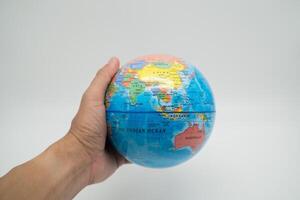 Global holding by hand with white background photo