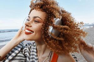 Joyful Afro-American Woman Listening to Music with Earphones on Beautiful City Street photo