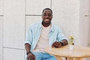 Man one african person cheerful young portrait sitting male american lifestyle modern casual guy photo