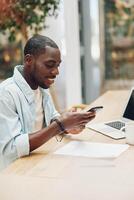 Man sitting working phone internet computer communication business young professional smiling photo