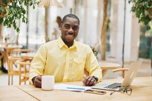 Man business african working sitting professional person businessman black male table modern photo