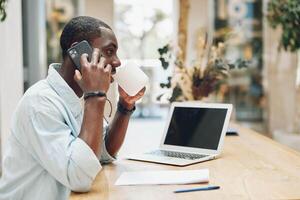 Man computer businessman job working entrepreneur sitting phone young male business office adult photo