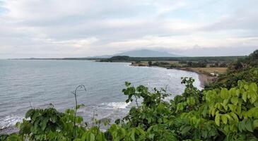 beautiful view of the beach and the sea on a cloudy day photo