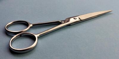 Hair cutting scissors on blue background. Hairdresser tools. photo