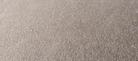 Closeup detail of beige fabric texture background. High resolution photo. photo
