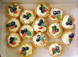 Assorted Berry Tartlets with Whipped Cream photo