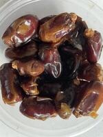 Muslim Ramadan Kareem with dates fruits, suitable for banner, copy space. Iftar party concept. photo