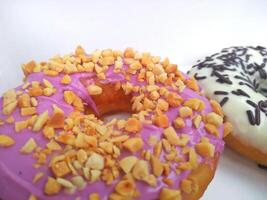 assorted donuts with chocolate frosted, pink glazed and sprinkles donuts. photo