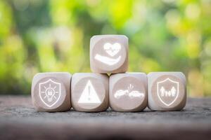 Insurance concept, Wooden block on desk with insurance icon on virtual screen. photo