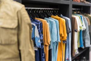 Assorted male clothing on shop rack photo