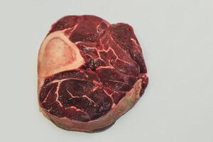 Fresh piece of meat big beef steak on the bone ossobuco. photo