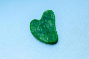Nephrite cosmetic massager Gouache on a blue background. photo
