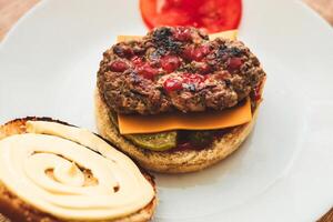 Buns for homemade burgers with ketchup and cutlet lie on a plate. photo