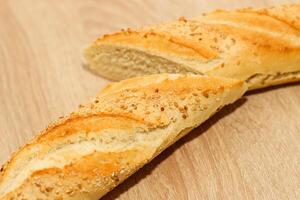 Fresh baguette made of white wheat flour with seeds and cereals photo