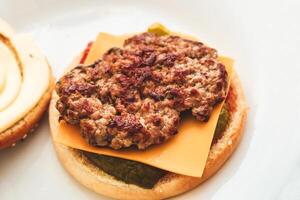 Buns for homemade burgers with ketchup and cutlet lie on a plate. photo