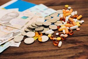 Ukrainian hryvnias with flag of Ukraine with pills and vitamins, healthcare concept. photo