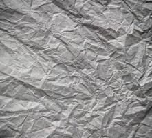 The texture of the crumpled gray paper. Abstract background. Selective focus. photo