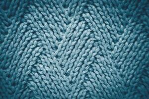 Knitted gray blue wool scarf with a diamond pattern. Abstract background. Close-up. Top view. Selective focus. photo