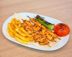 White Plate With Chicken and French Fries photo