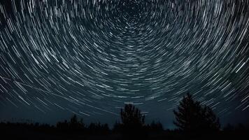 Stars move around a polar star. Time lapse of Star trails in the night sky. 4K video