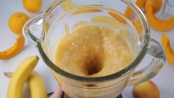 Obst Smoothie vermischt im Mixer, Super schleppend Bewegung. orange, Banane, Apfel im ein Mixer, oben Sicht. gesund und Vegetarier Essen Konzept video