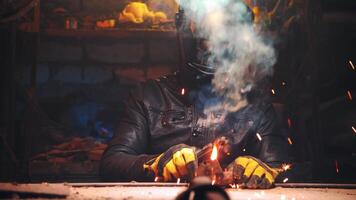 Dramatic shot of a man welding in an old garage, working with steel, close-up of a work place, welding as a hobby video