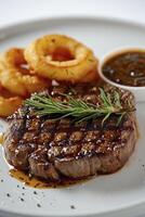 AI generated A steak served with peppercorn sauce and accompanied by onion rings, presented on a white background. photo