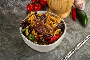 Asian wok with noodle, vegetables and beef photo