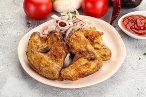 Grilled chicken wings with sauce photo