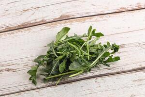 Green Arugula heap over background photo