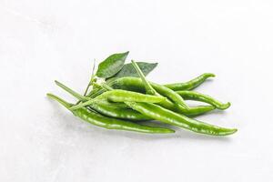 Spicy green chili pepper heap photo